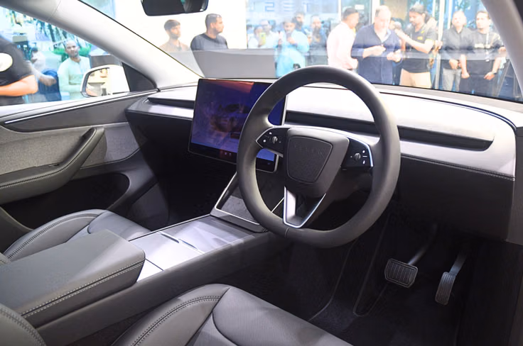Only physical controls are found on the steering wheel; no instrument cluster. Tesla Model Y interior