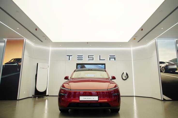 Tesla dealerships in India will function on a direct-sales model. Tesla showroom India with Model Y and Supercharger