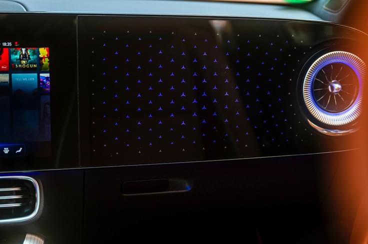 Passenger side of the dashboard also gets three-point star motif that lights up in sync with the ambient lighting package. Mercedes-Benz CLA EV ambient lighting on dashboard.