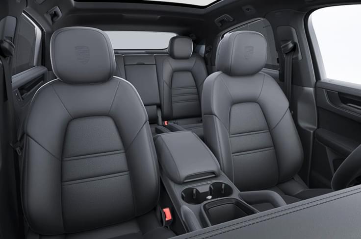 Both SUVs feature black leather upholstery, brushed aluminium accents, and illuminated door sills. Porsche Cayenne and Cayenne Coupe Black Edition interior seats