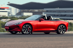 Side profile of red MG Cyberster electric roadster at high speed