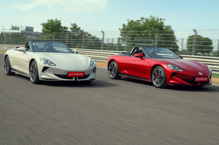 MG Cyberster electric cars in red and white driving on race track together