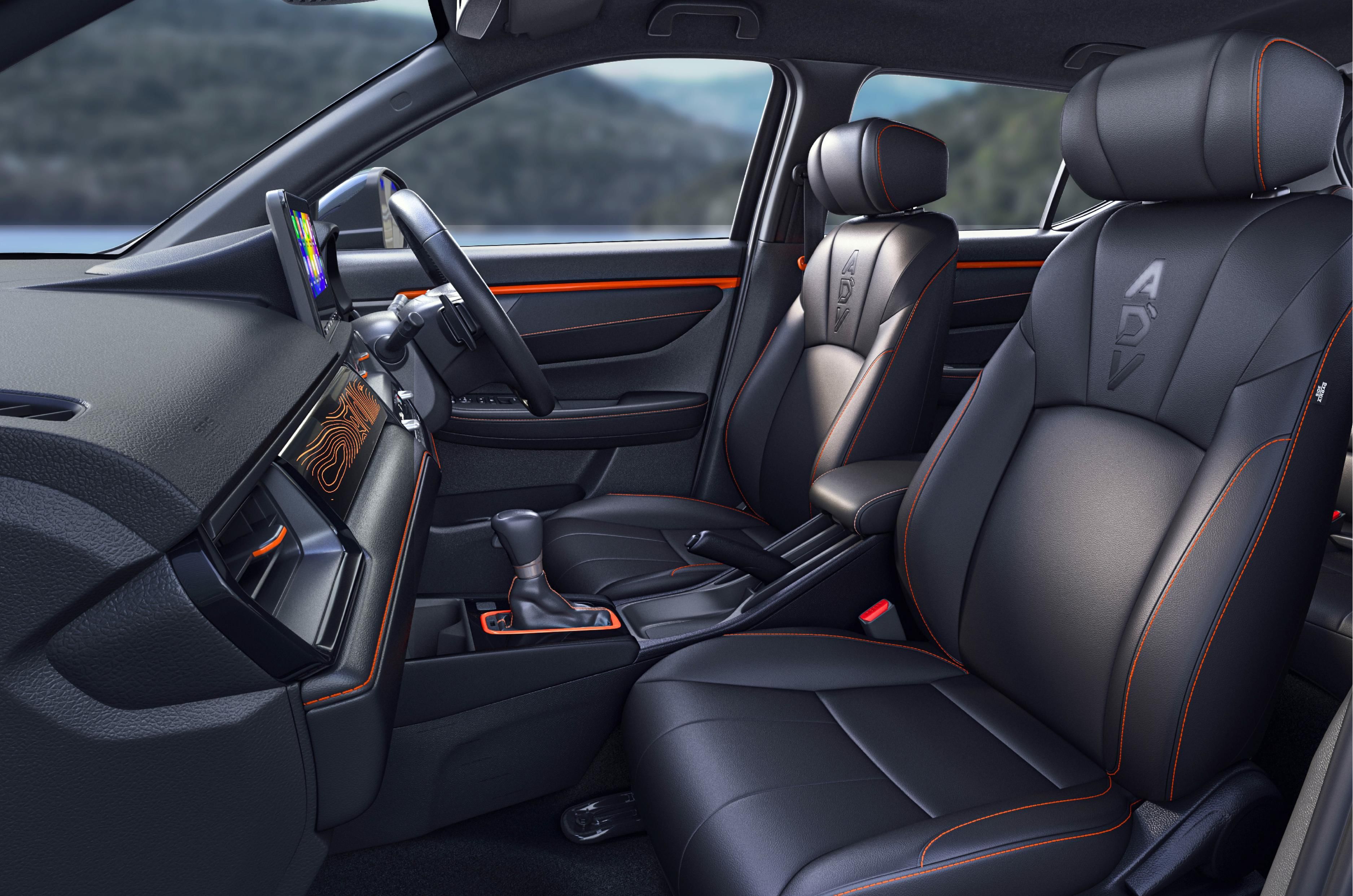 The interior features ADV embossed black seats with orange stitching

